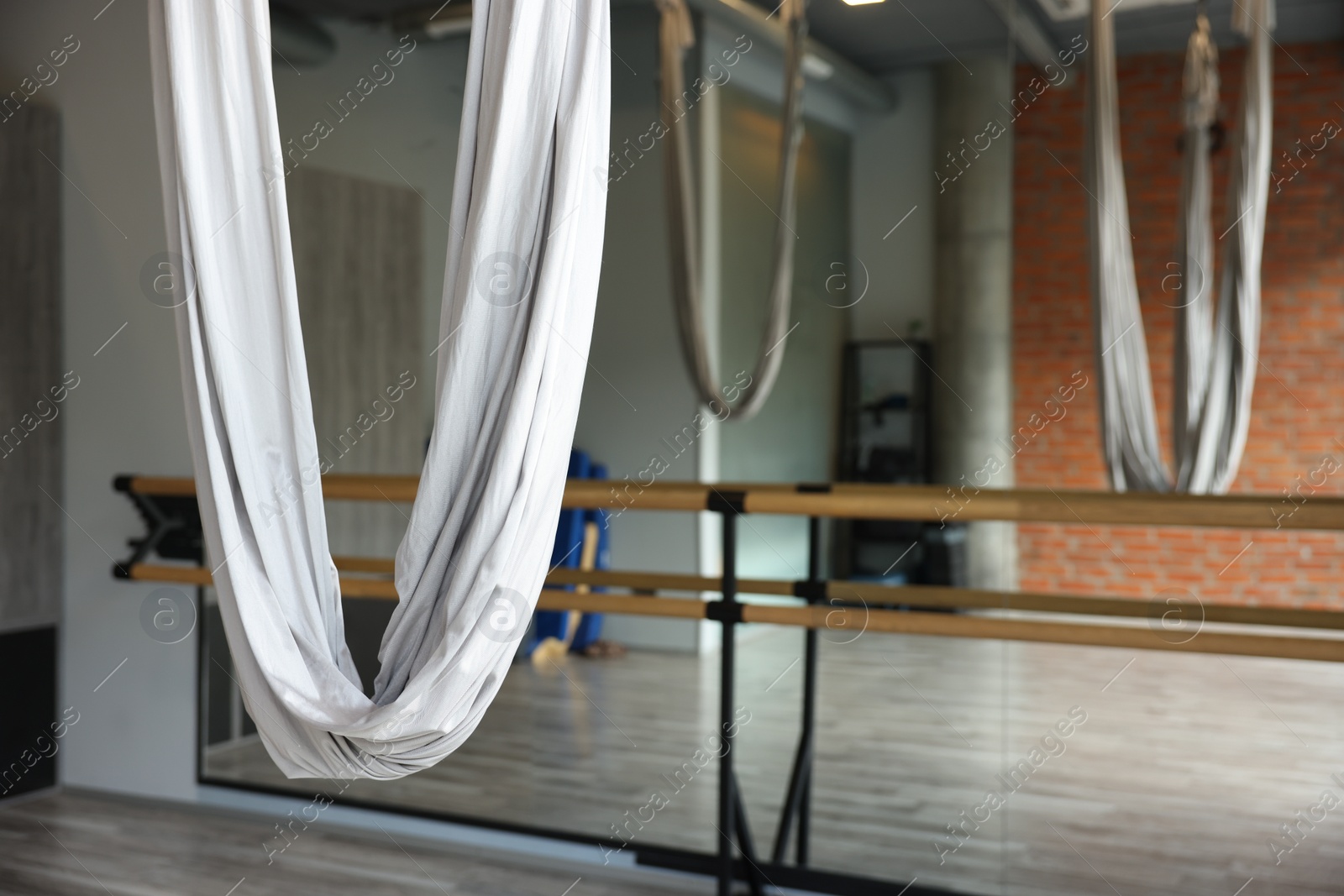 Photo of Many hammocks for fly yoga in studio, space for text