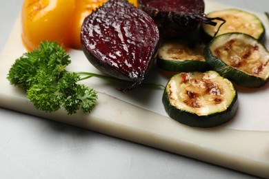 Photo of Delicious grilled vegetables on light table, closeup