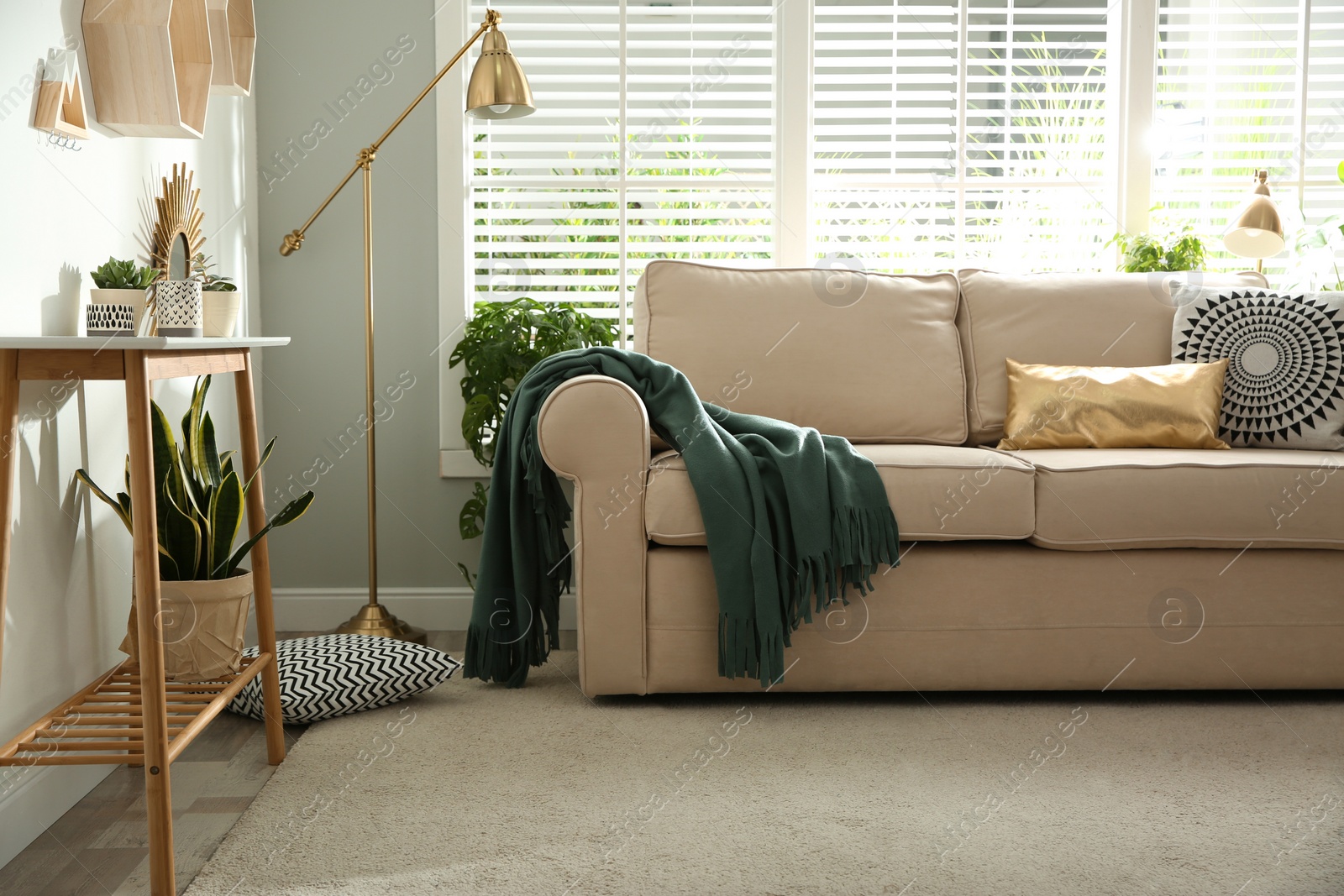 Photo of Stylish beige sofa in modern living room interior