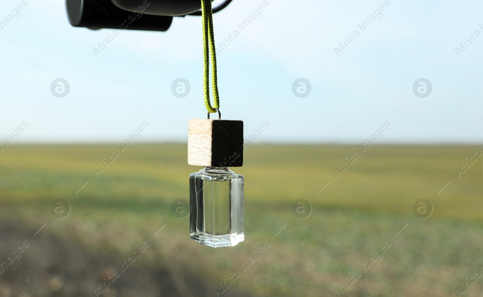 Photo of Car air freshener hanging on blurred view, closeup