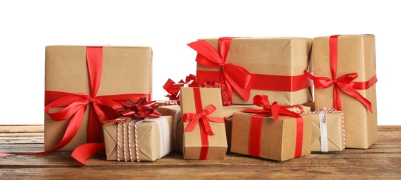 Many Christmas gifts on wooden table against white background