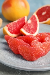 Plate with ripe grapefruit on table. Fresh fruit