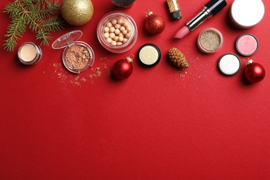 Photo of Flat lay composition with makeup products and Christmas decor on color background. Space for text