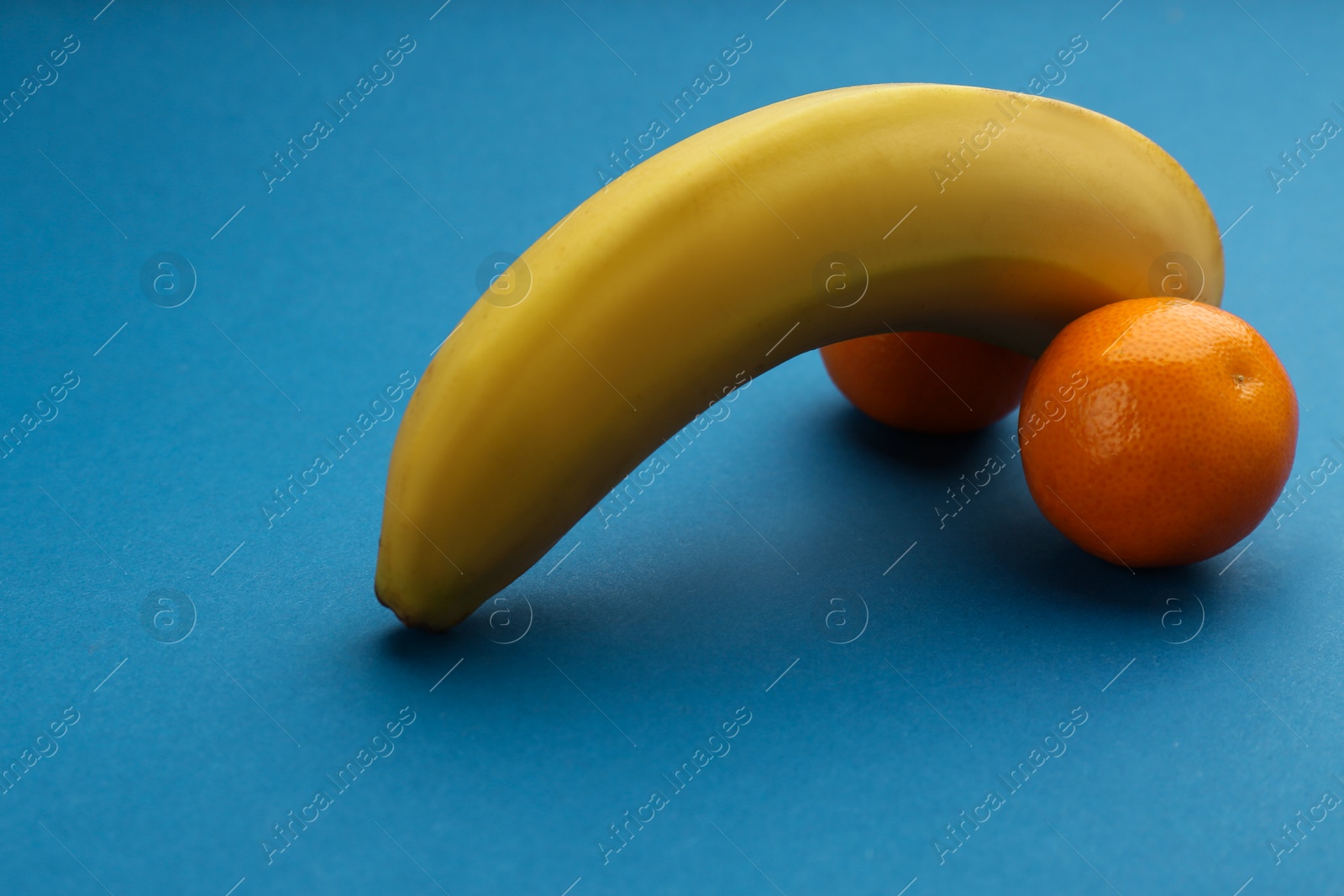 Photo of Fruits symbolizing male sexual organ on blue background. Potency problem