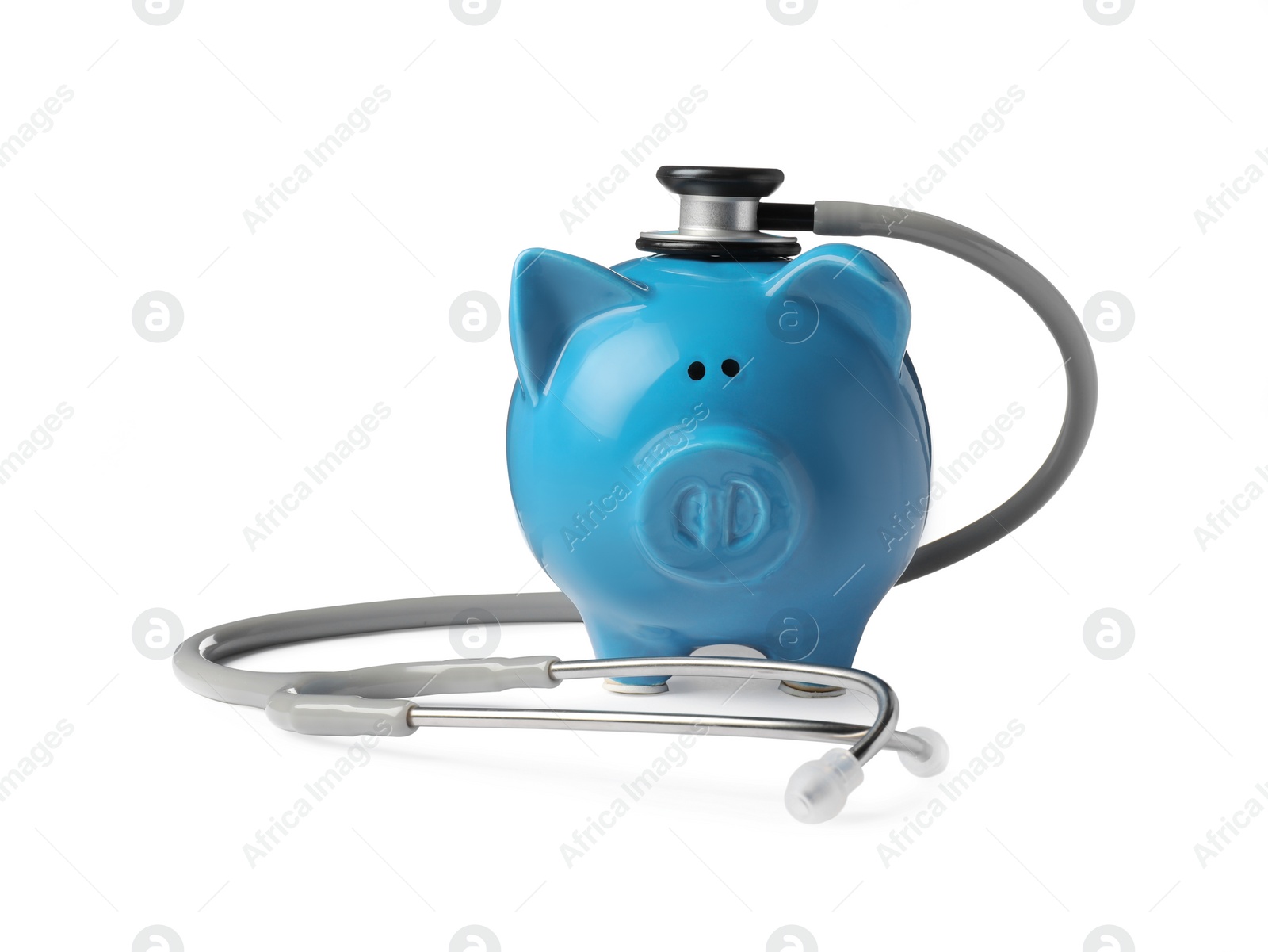 Photo of Piggy bank with stethoscope on white background. Medical insurance