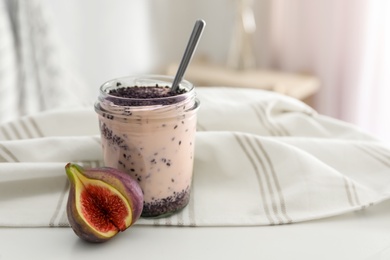 Delicious fig smoothie in glass jar on white table indoors