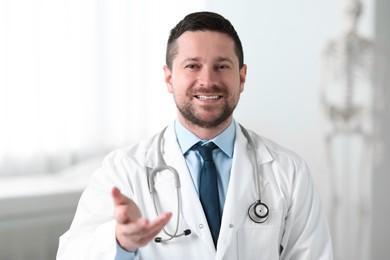 Photo of Portrait of smiling doctor with stethoscope in clinic