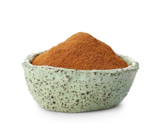 Photo of Bowl with aromatic cinnamon powder on white background