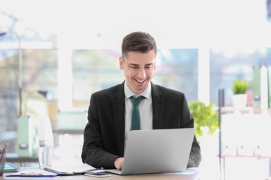 Consultant working at table in office