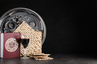 Photo of Symbolic Pesach (Passover Seder) items on black table, space for text