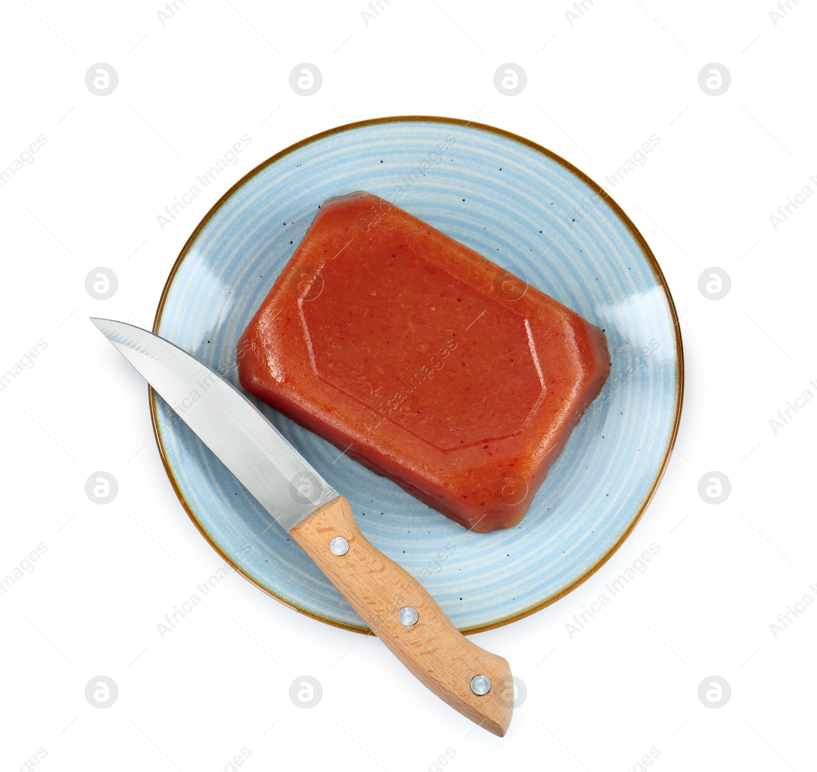 Photo of Delicious sweet quince paste and knife isolated on white, top view