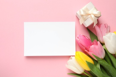 Photo of Beautiful spring tulips and card on color background, top view with space for text. International Women's Day