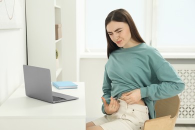 Photo of Diabetes. Woman making insulin injection into her belly at table indoors