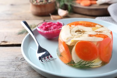 Photo of Delicious chicken aspic served on wooden table, closeup