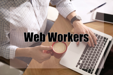 Image of Man with cup of coffee working on laptop at table in office, above view. Web workers