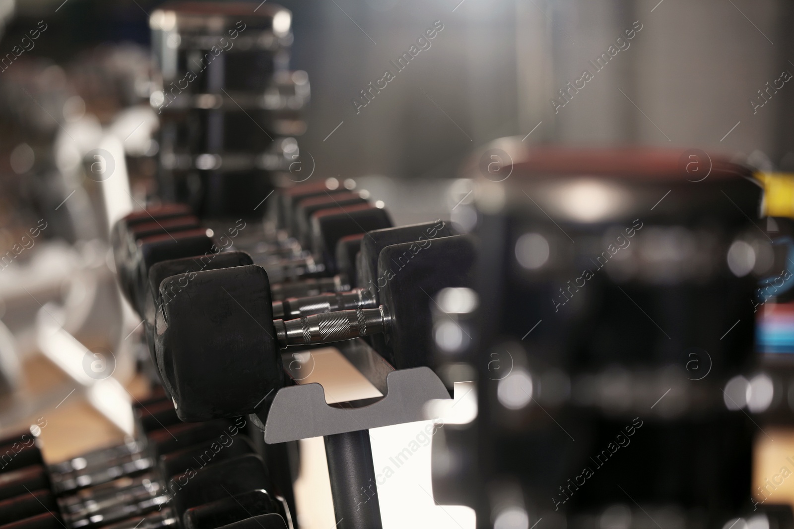 Photo of Modern sports equipment in gym. Space for text