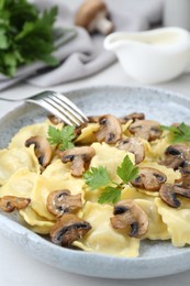 Delicious ravioli with mushrooms on white table, closeup