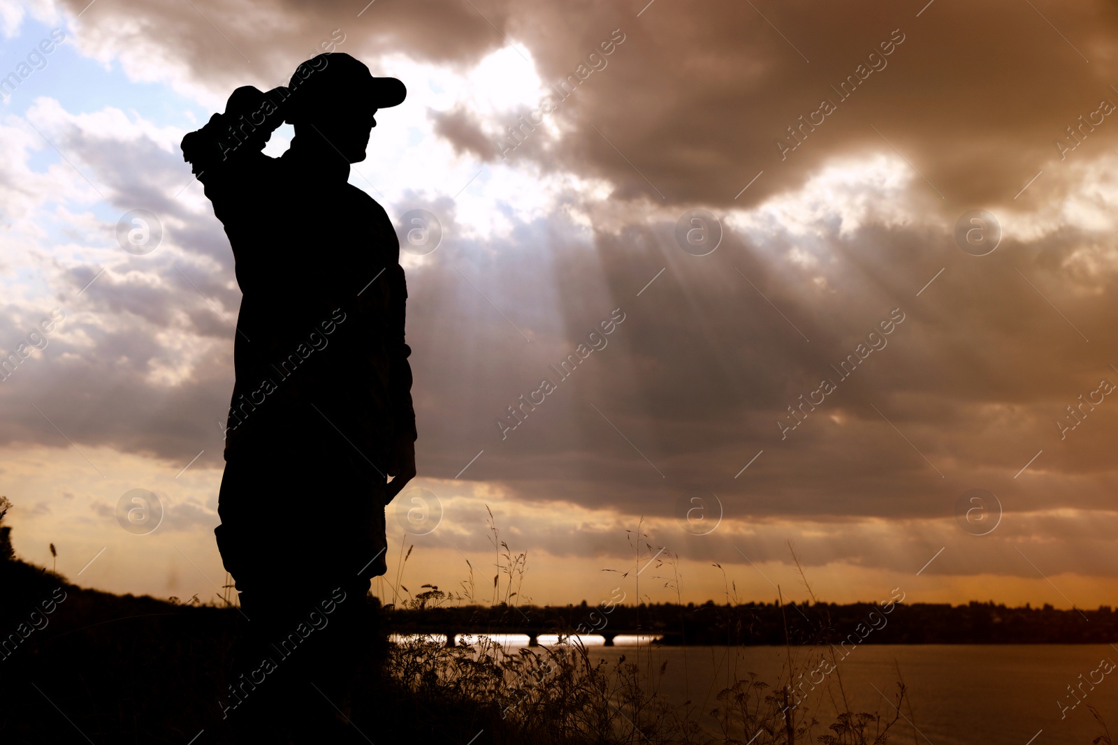 Photo of Soldier in uniform saluting outdoors. Military service