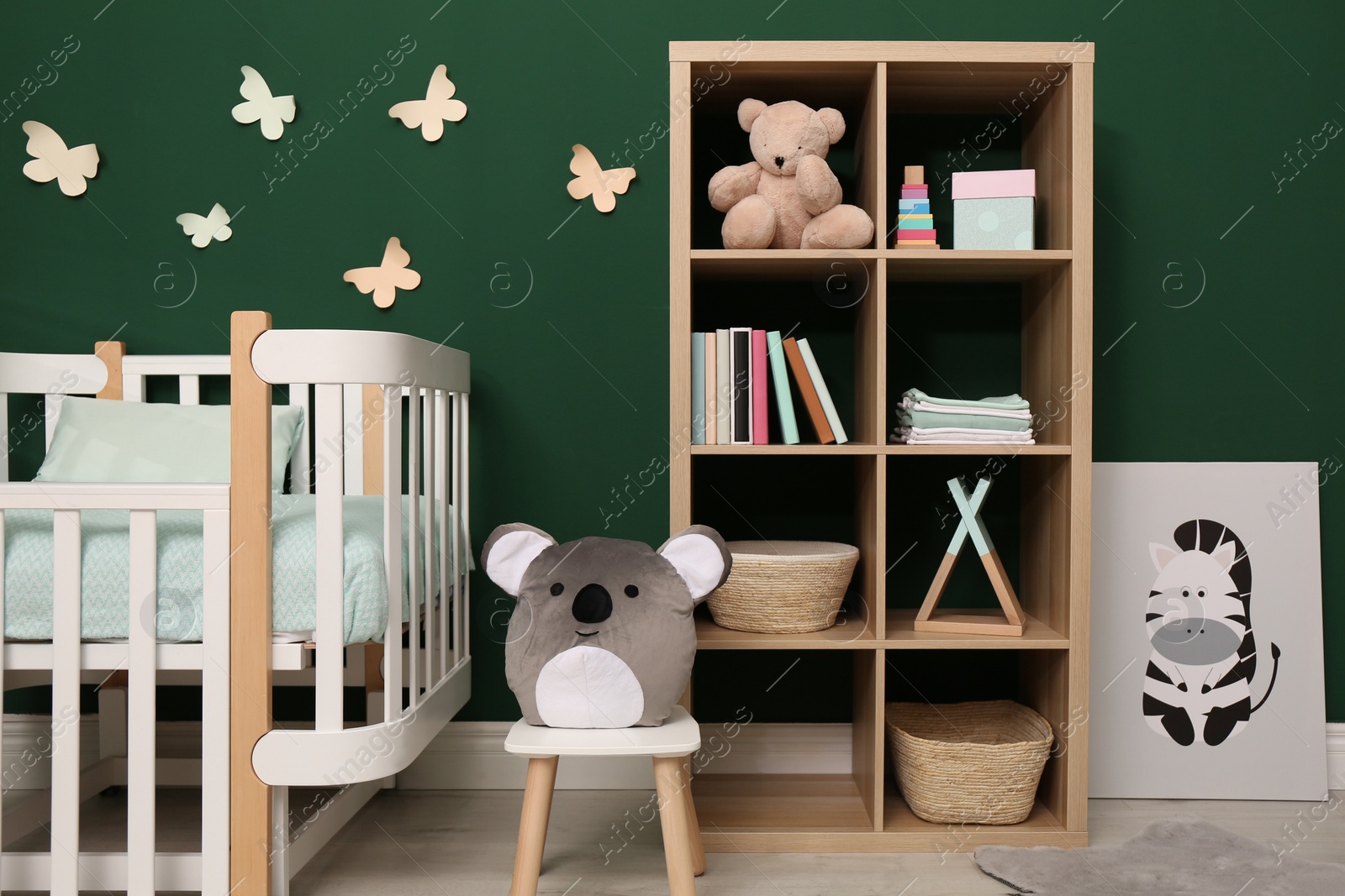 Photo of Beautiful baby room interior with stylish furniture and comfortable crib