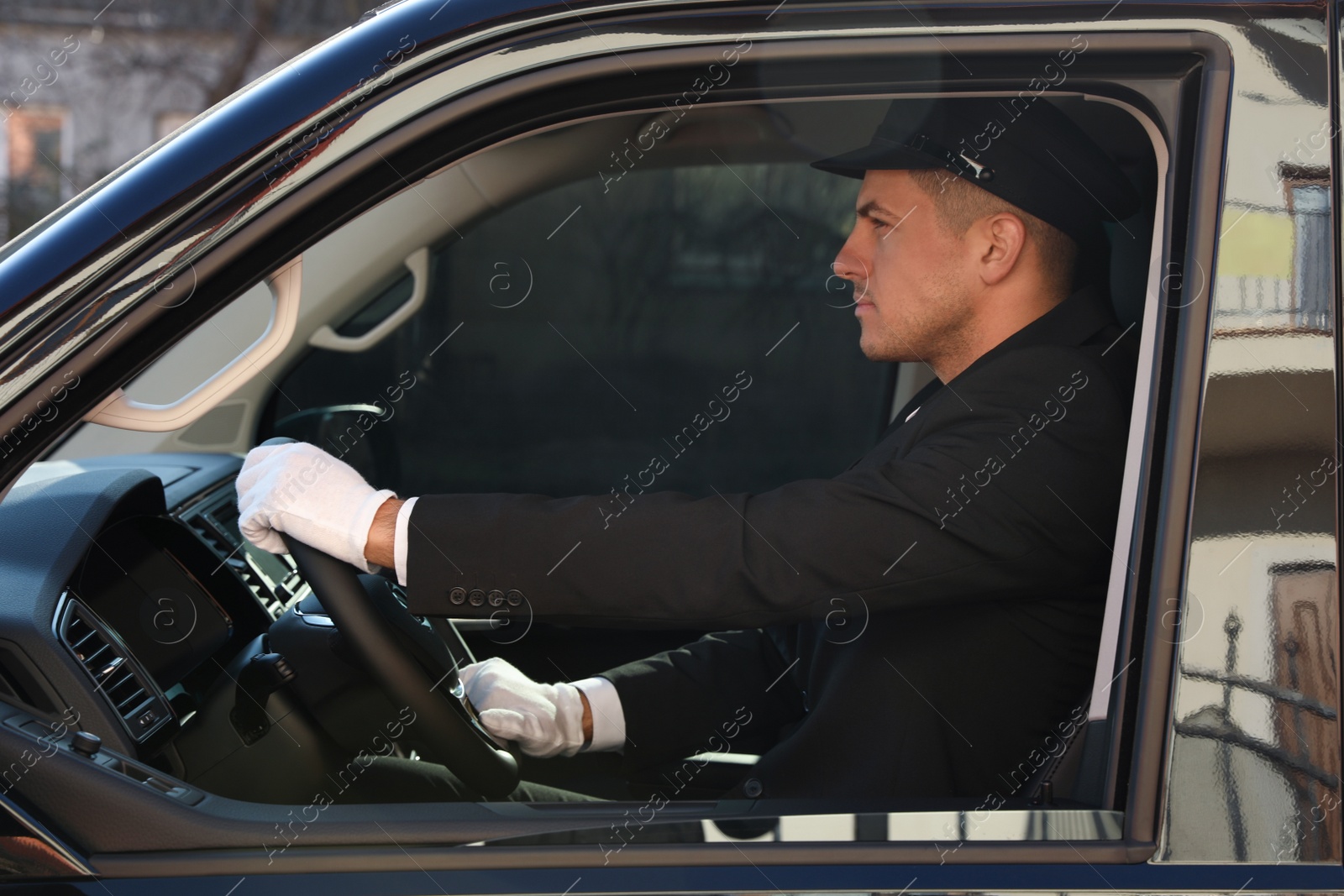 Photo of Professional driver in luxury car. Chauffeur service