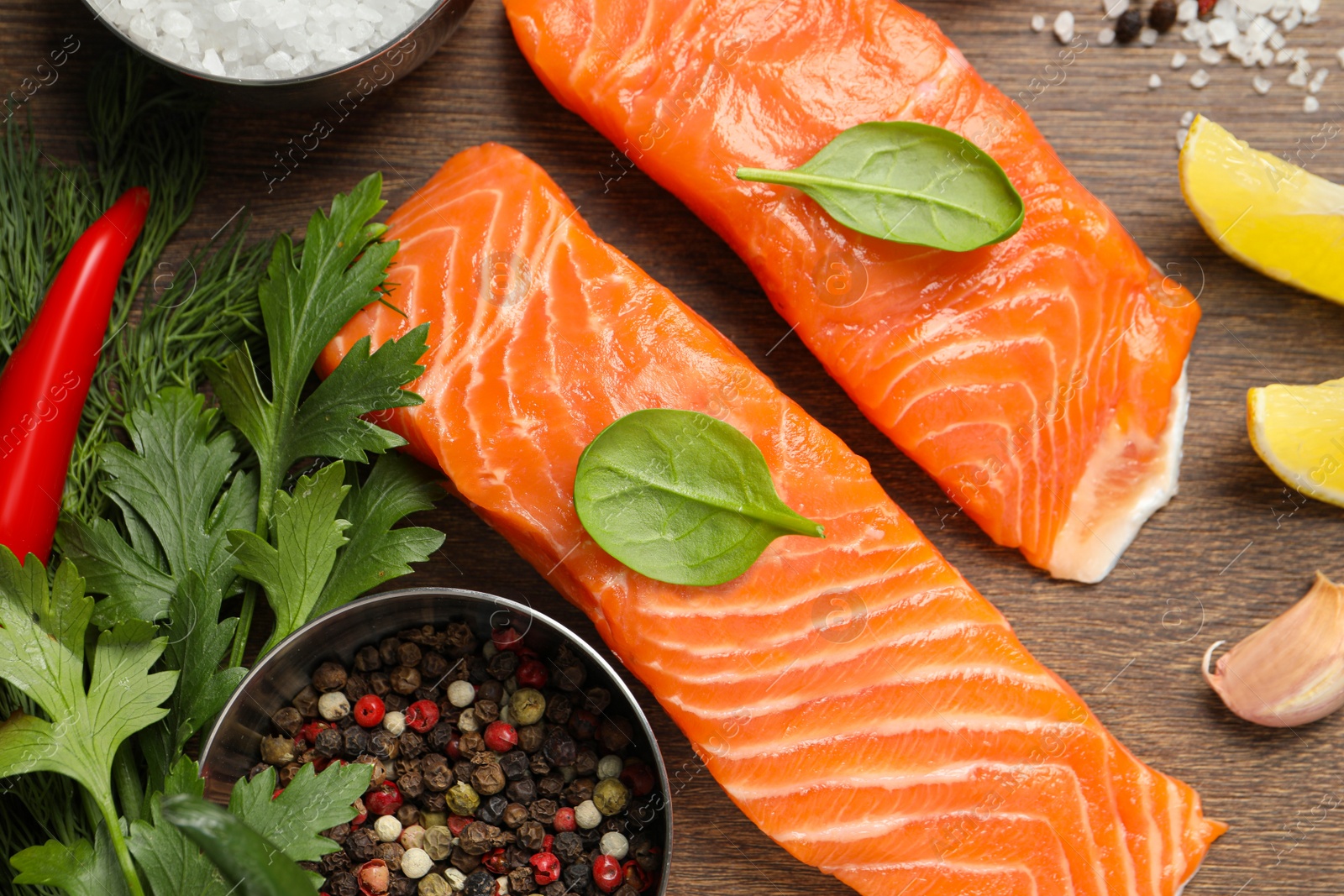 Photo of Fresh salmon and ingredients for marinade on wooden table, flat lay