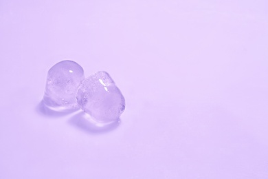 Photo of Ice cubes on color background. Space for text