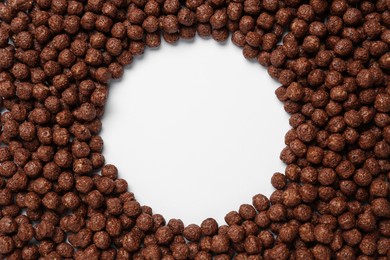 Photo of Frame of sweet crispy chocolate corn balls on white background, top view. Space for text