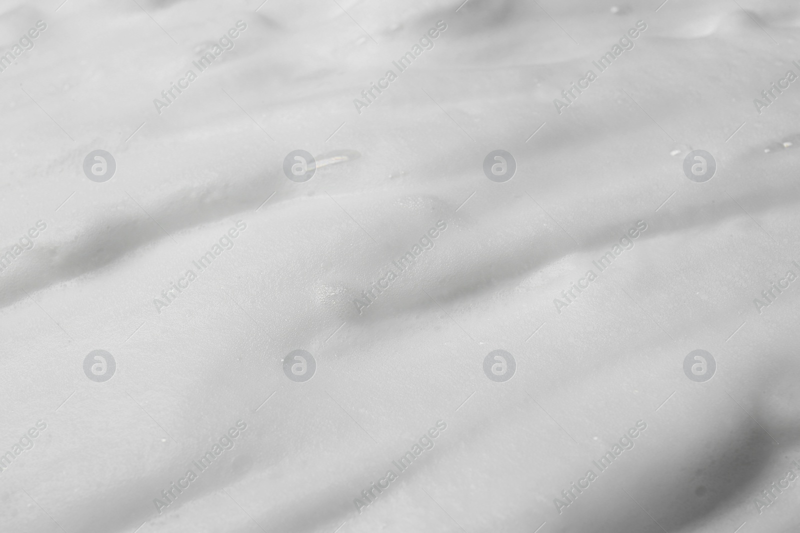 Photo of Foam as background, closeup. Face cleanser, skin care cosmetic