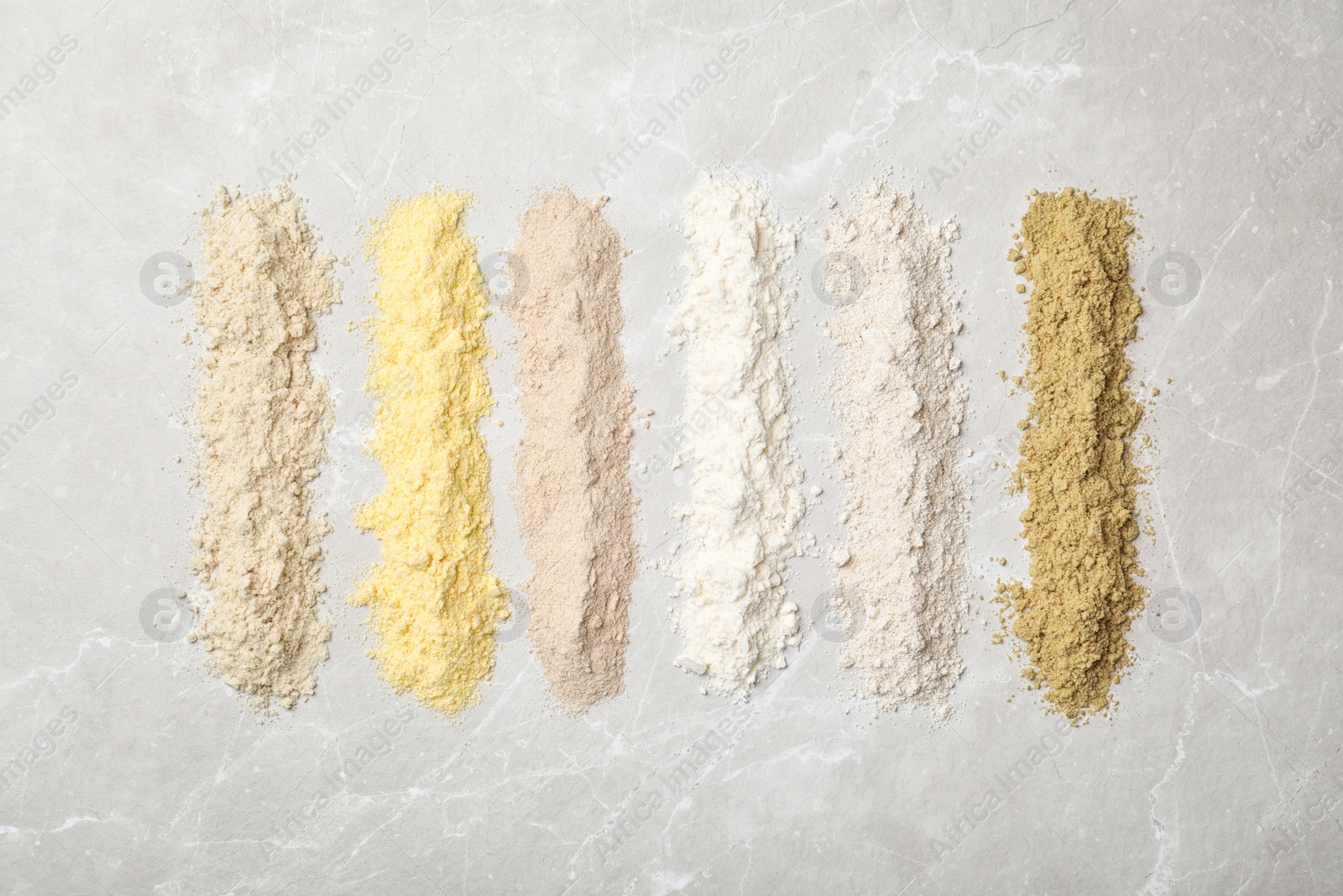 Photo of Composition with different types of flour on light background