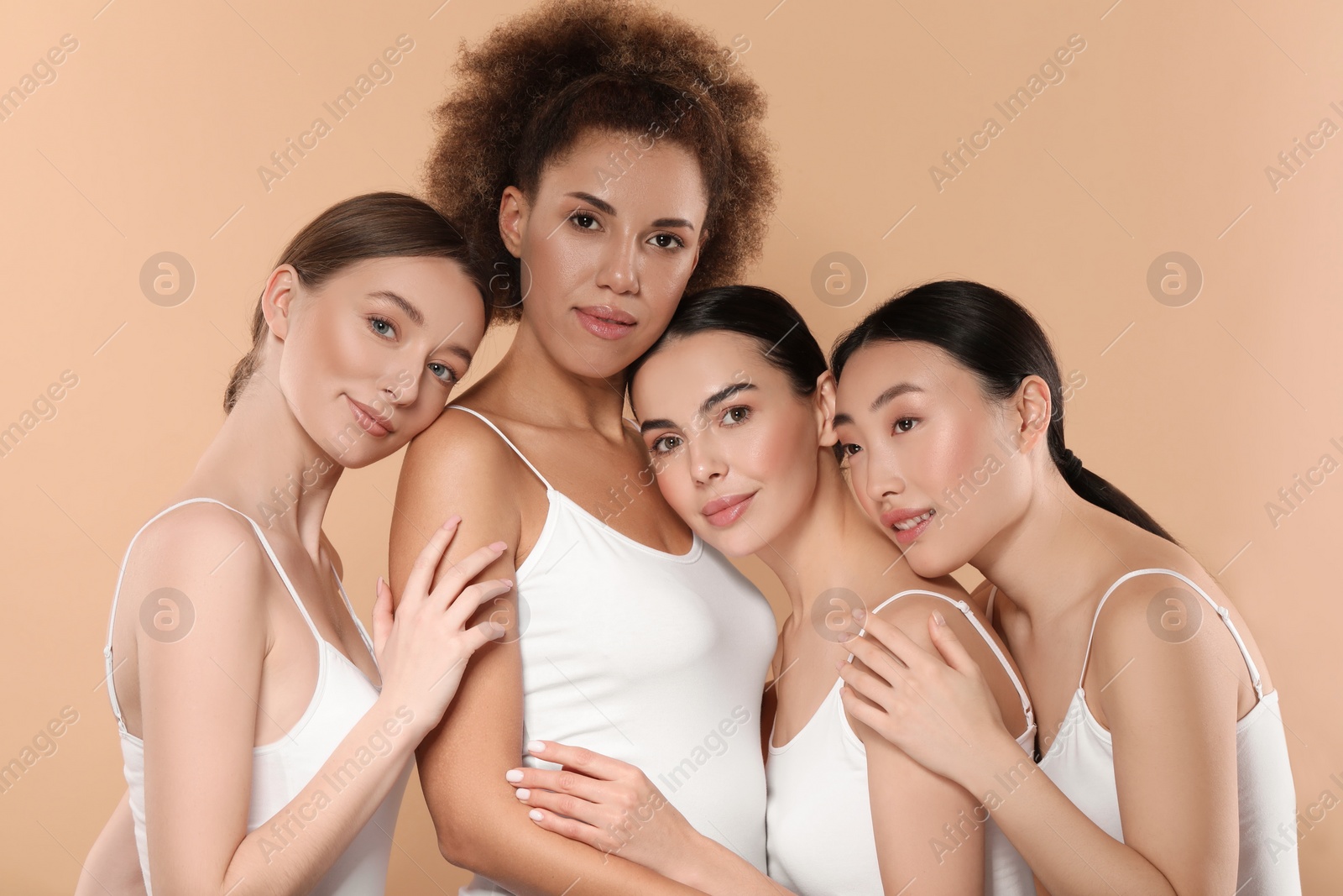 Photo of Beautiful young women with healthy skin on beige background