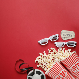 Photo of Flat lay composition with delicious popcorn on red background