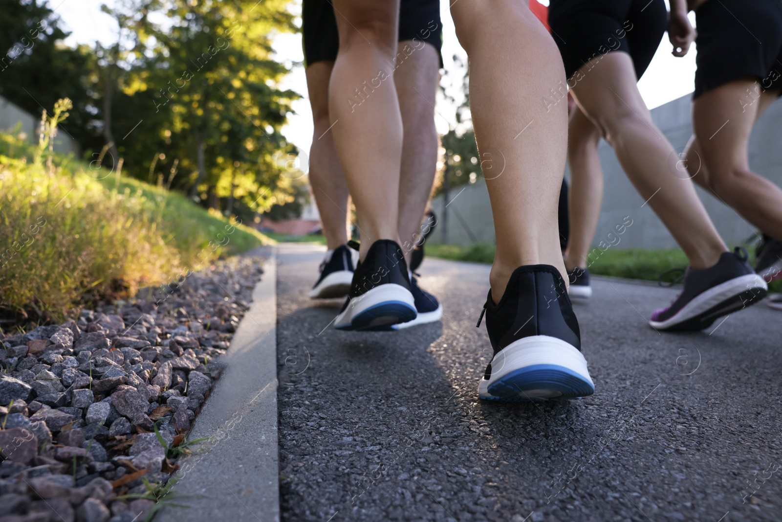 Photo of Group of people running outdoors, closeup view