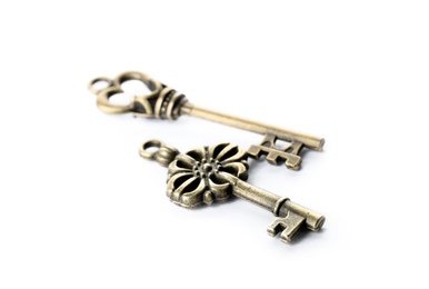 Photo of Bronze vintage ornate keys on white background