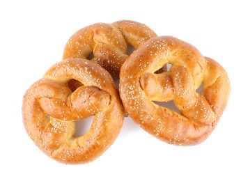 Tasty freshly baked pretzels on white background, top view