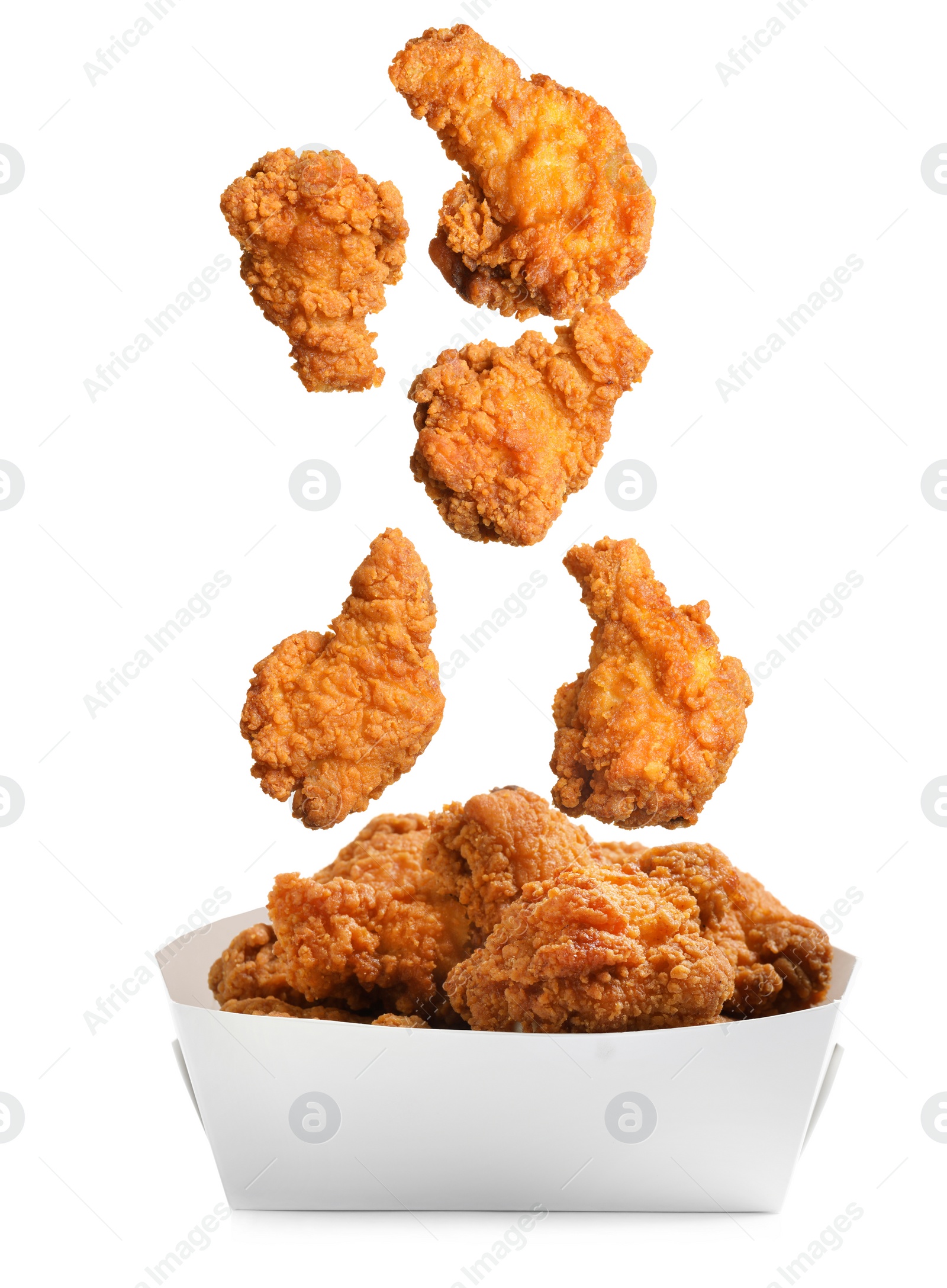 Image of Fresh fried chicken falling into container on white background