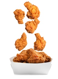 Image of Fresh fried chicken falling into container on white background