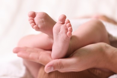 Photo of Mother and her newborn baby on bed, closeup view