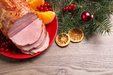 Photo of Flat lay composition with delicious ham served on wooden table. Christmas dinner
