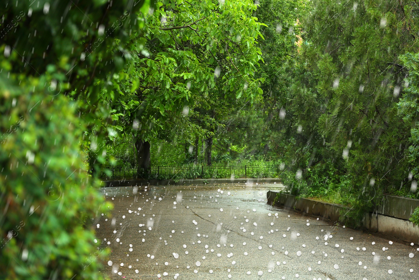 Image of View of city street on rainy day with hail