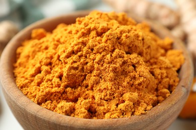 Aromatic turmeric powder in bowl, closeup view