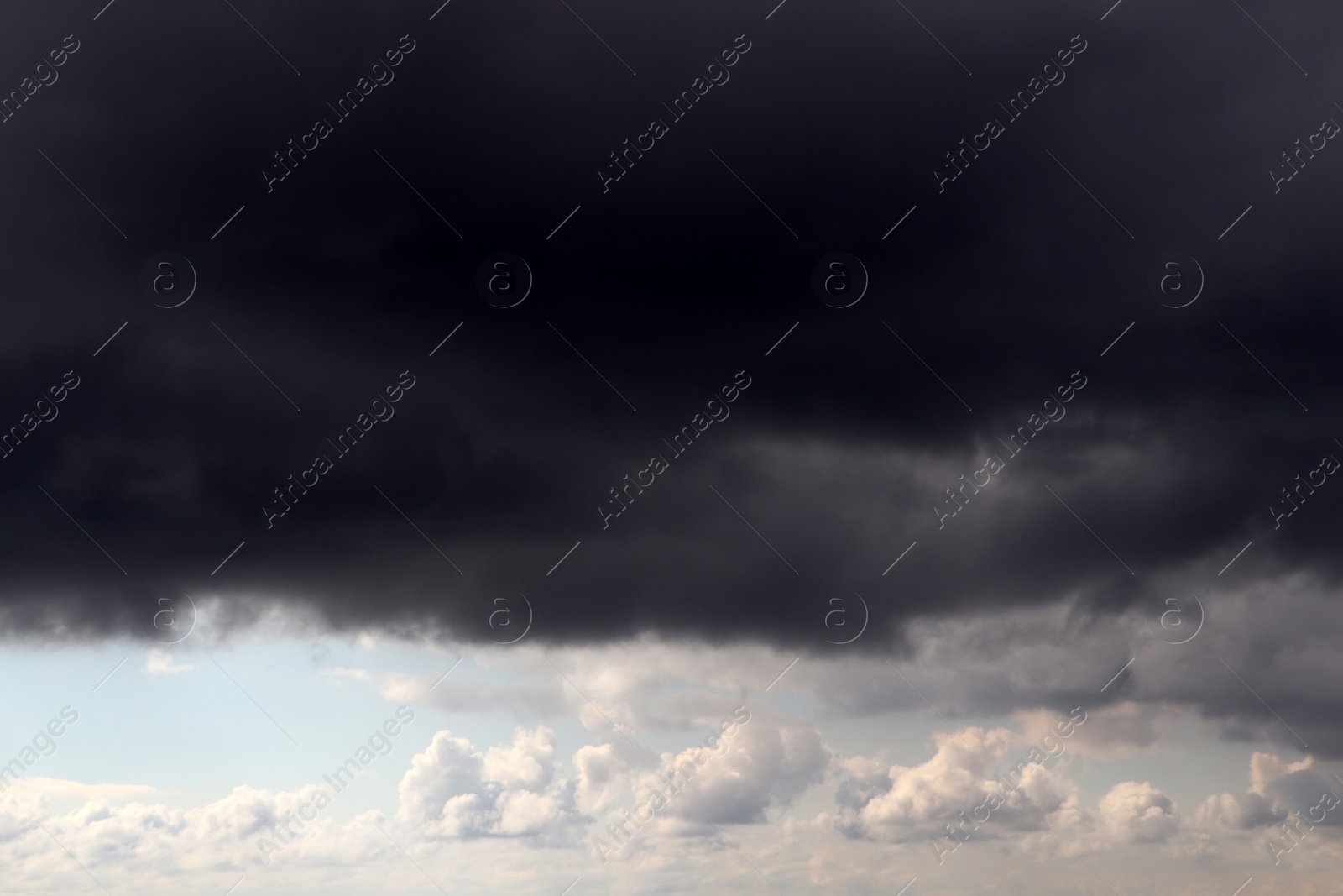 Photo of Sky with heavy rainy clouds on grey day