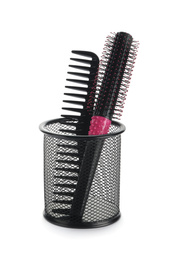 Photo of New modern hair brush and comb in metal holder isolated on white