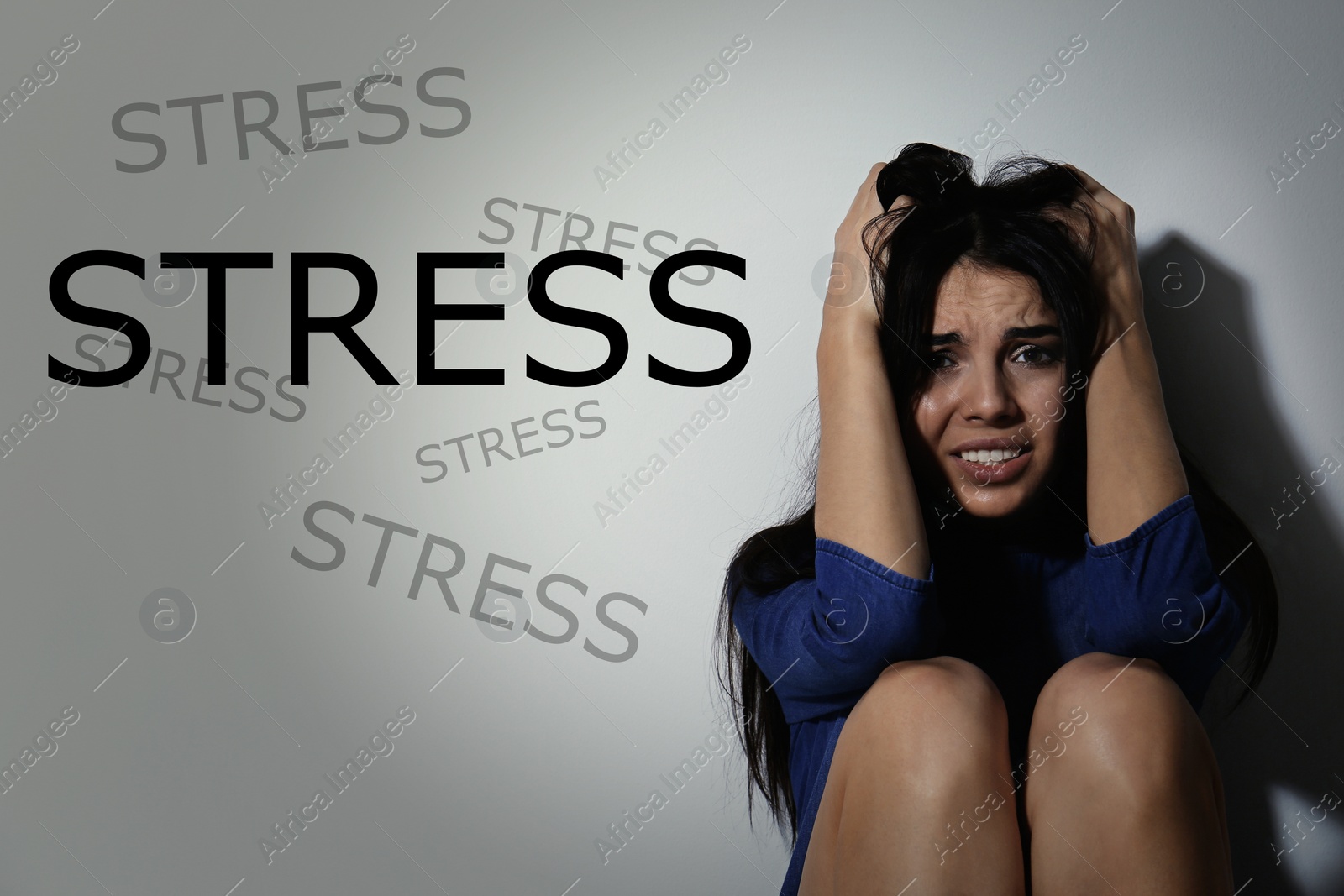 Image of Depressed young woman near white wall and word STRESS