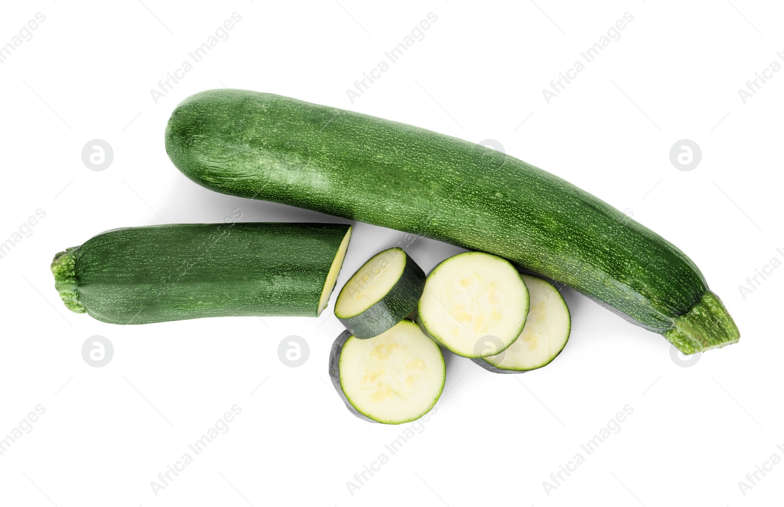 Photo of Cut and whole green ripe zucchini isolated on white, top view
