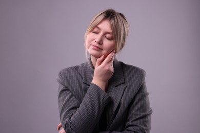 Portrait of beautiful young woman on grey background