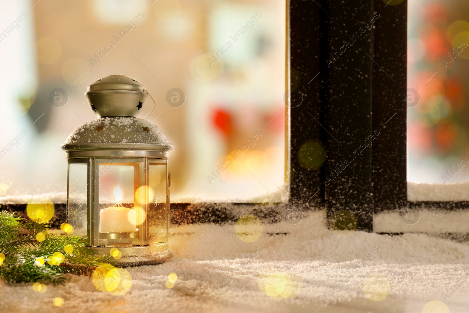 Image of Lantern with candle and fir branches near window outdoors. Christmas eve