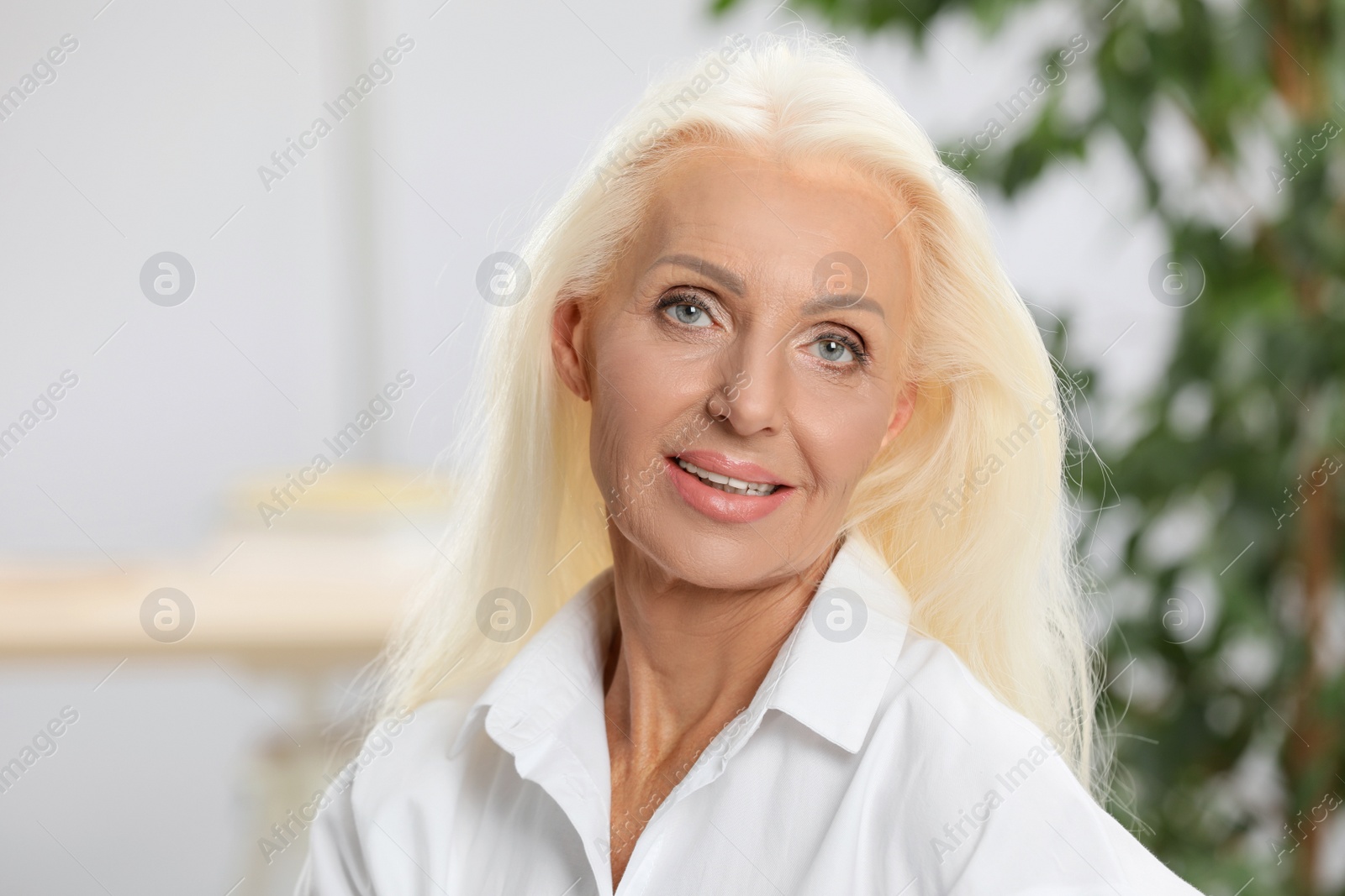 Photo of Portrait of happy mature woman at home