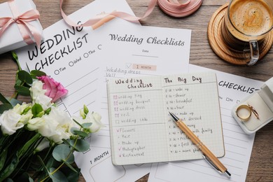 Photo of Flat lay composition with Wedding Checklists on wooden table