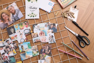 Photo of Flat lay composition with different photos, stationery and metal grid on wooden background. Creating vision board