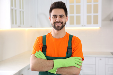 Photo of Professional janitor in uniform indoors. Cleaning service